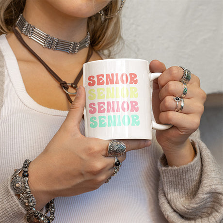 Woman holding 2024 senior class coffee mug. Perfect gift for class of 2024 graduates. All SKUs.