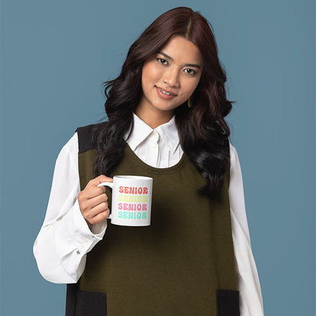 Woman holding class of 2024 graduation gift for her. A coffee mug with inscription Senior for class of 2024. All SKUs.