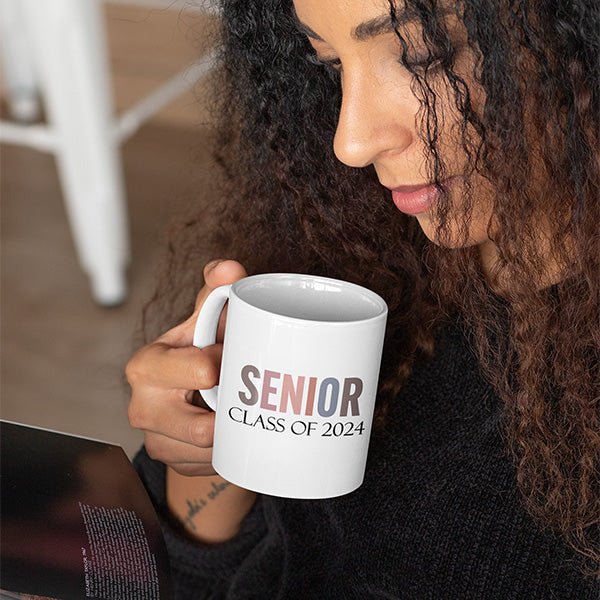 Woman drinking from a 2024 senior class coffee cup. Perfect gift for this years graduate celebration. All SKUs.