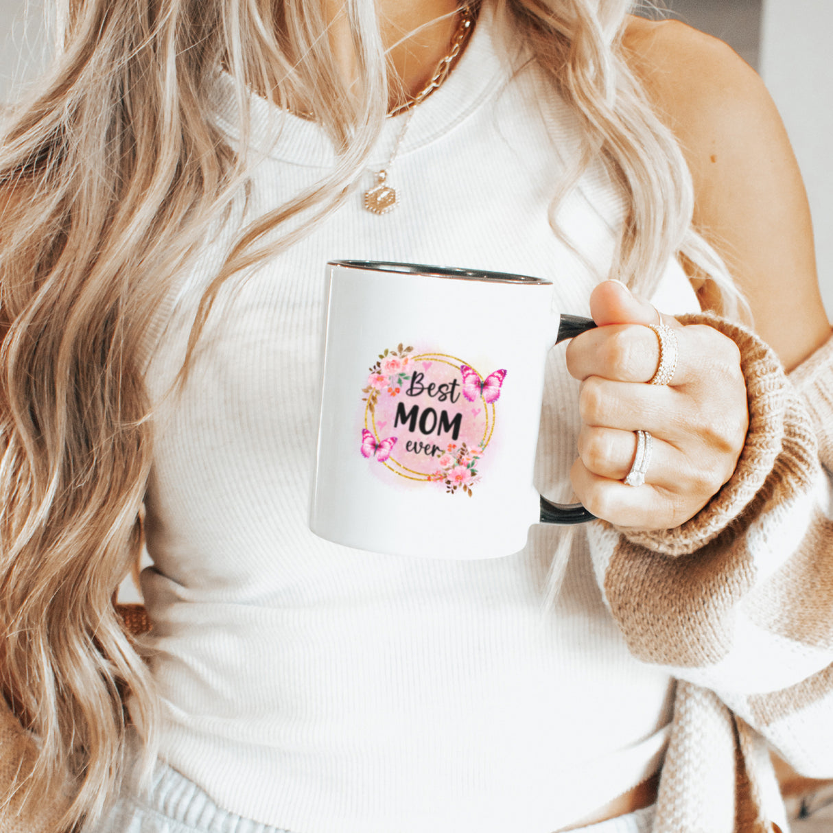 Mom holding a custom floral design mug for Mother’s Day. Birthday gifts for mom with the heartfelt Best Mom Ever design.