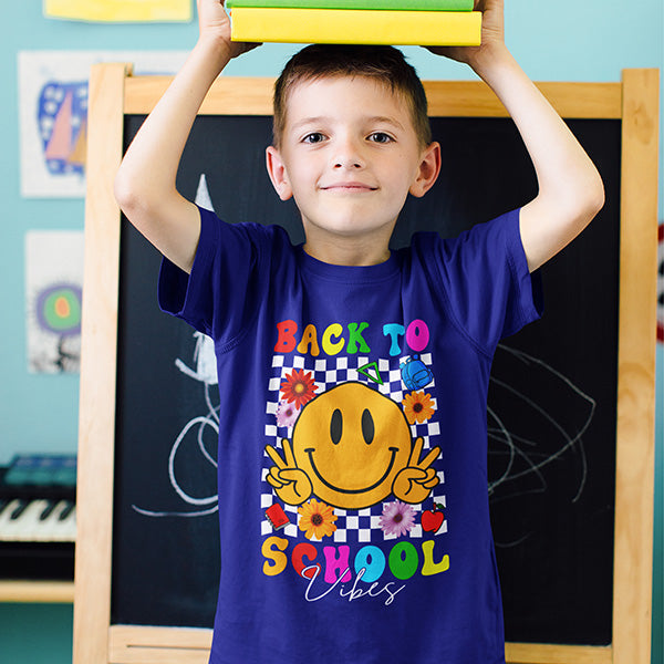 Back to school tshirts for boys and girls with smiley face and retro vibe indicating fun and positivity. These child shirts are available from sizes 2T to YXL and there are also adult sizes for teachers. all SKUs
