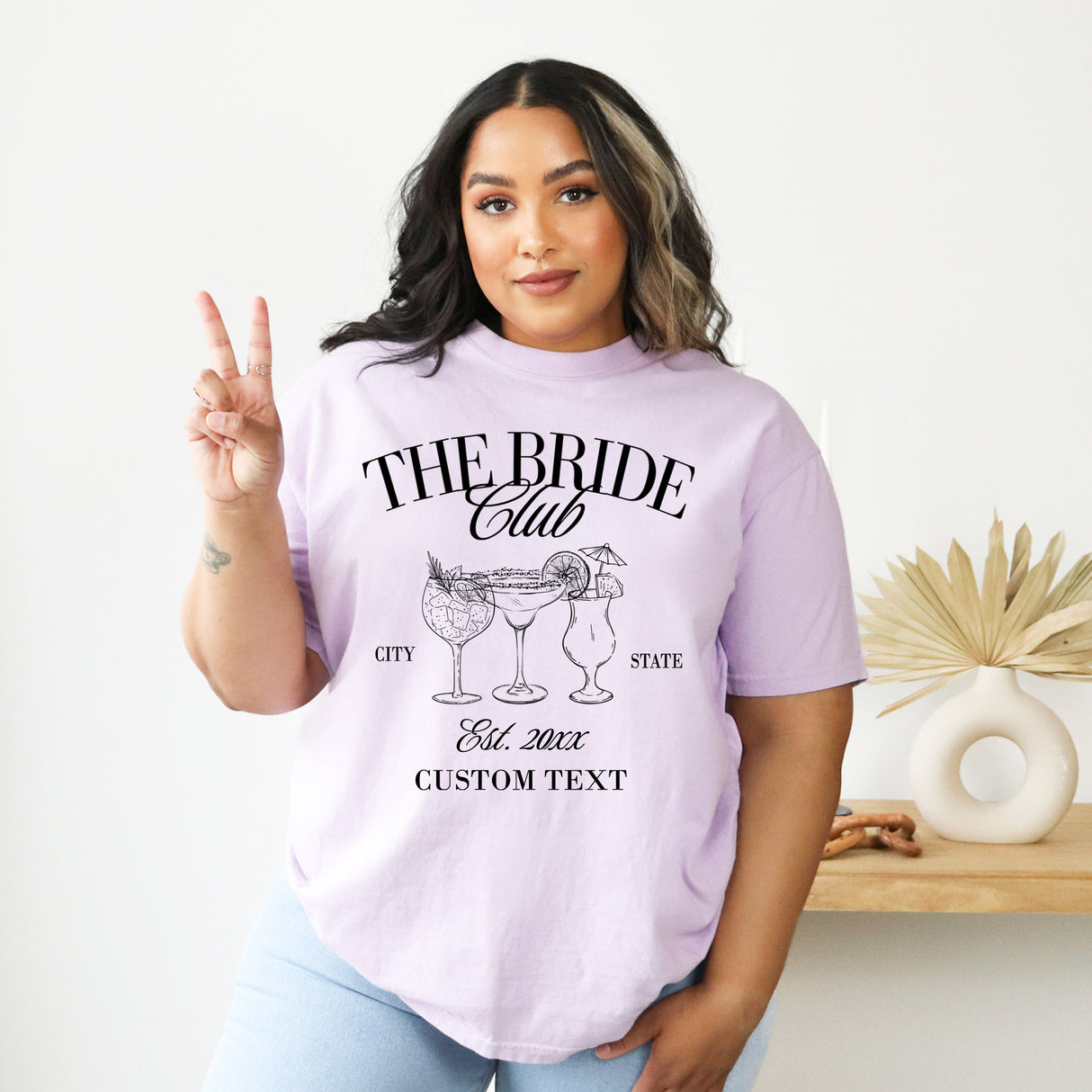 Bride wearing a custom Comfort Colors bachelorette shirt with personalized text, perfect for pre wedding celebration.