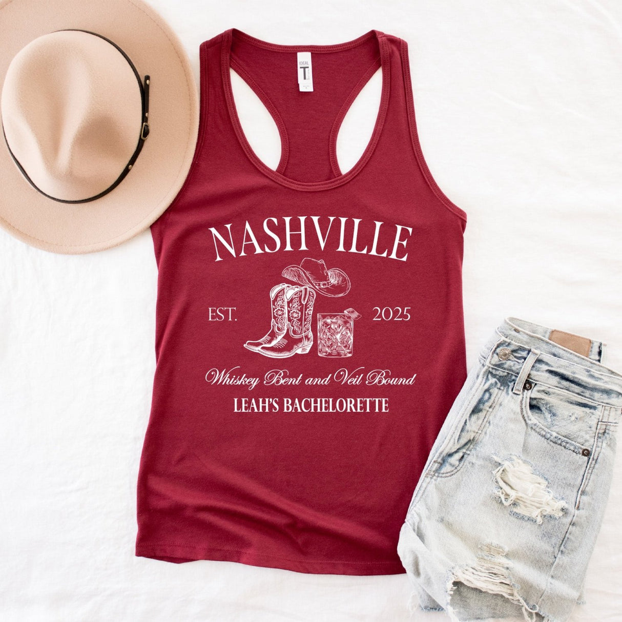 Flat lay of personalized Nashville bachelorette tank tops with custom bride and bridesmaid names, perfect for country themed bridal parties.