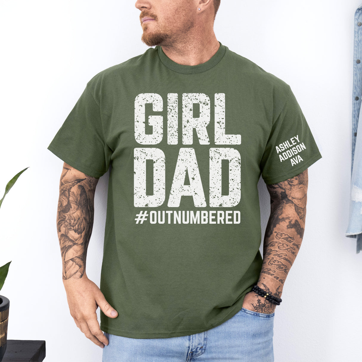 Green personalized dad of girls outnumbered shirt featuring custom daughters names, perfect Father's Day gift for proud girl dads.