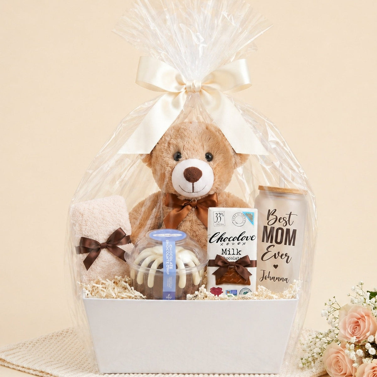 Gift basket with chocolate bundt cake, chocolate bar, teddy bear, fuzzy socks and personalized glasscan with the words Best Mom Ever and her name. Great gift for mothers day, birthdays and just because.