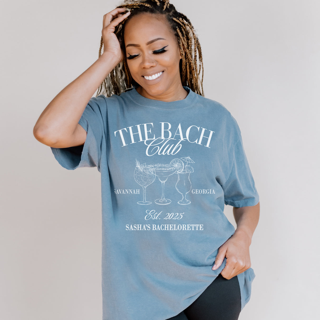 Personalized Comfort Colors bachelorette shirt inside a bridesmaid gift box, featuring custom names for the bridal party.