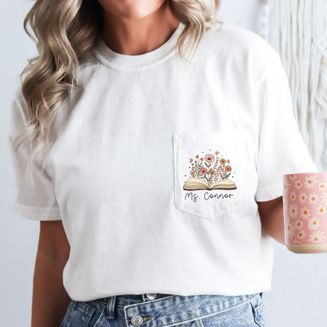 Female teacher in custom Comfort Colors name shirt with floral print, teacher appreciation week outfit.