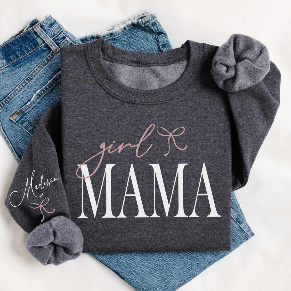 Grey personalized Girl Mama Sweatshirt with kids' names and coquette bow design. Custom Girl Mama Sweatshirt featuring year she became a mom.