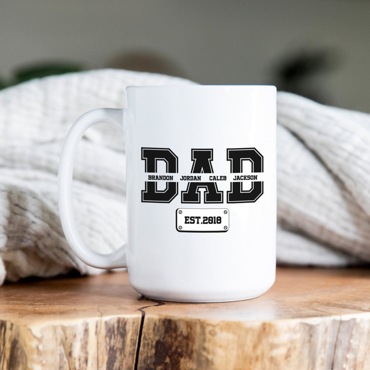 Custom dad mug with children’s names and year in varsity lettering, perfect personalized Father’s Day gift from kids or spouse.