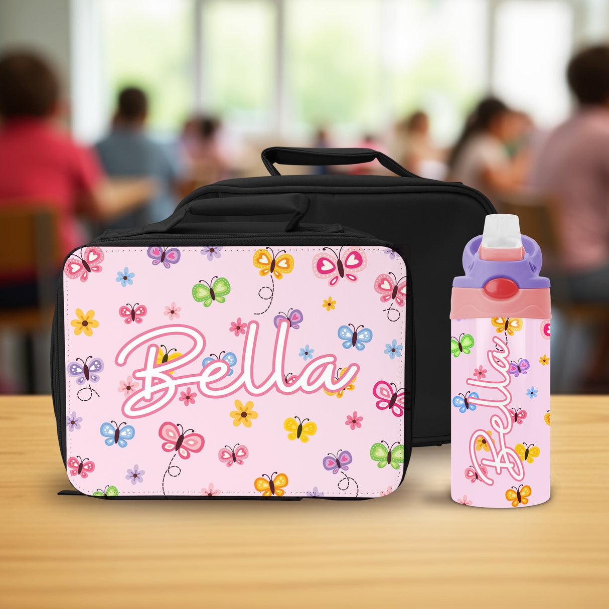 A vibrant and fun girls lunch box with name and matching custom water bottle, featuring a butterfly design.