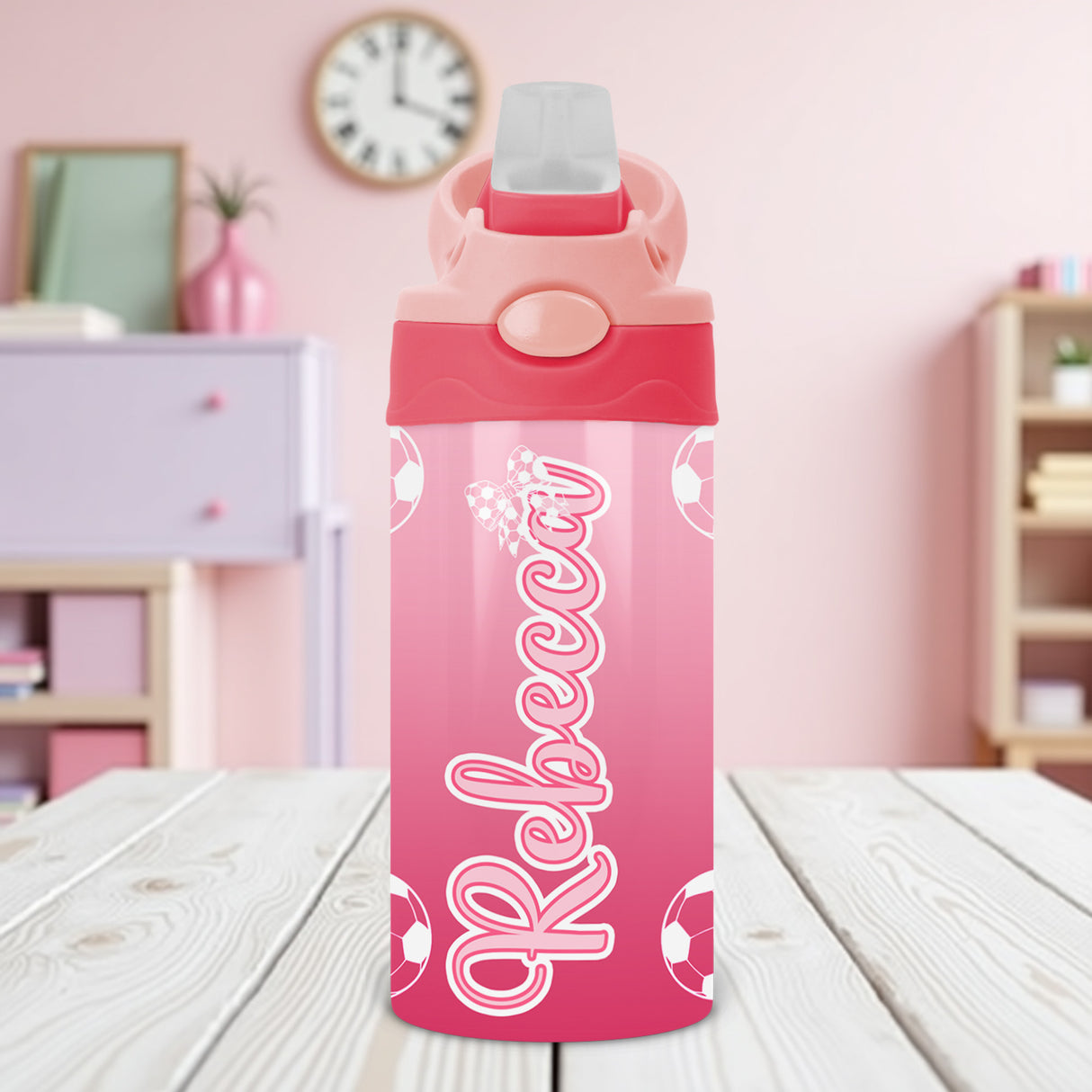 Kids custom water bottle featuring pink soccer design and name personalization for youth athletes.