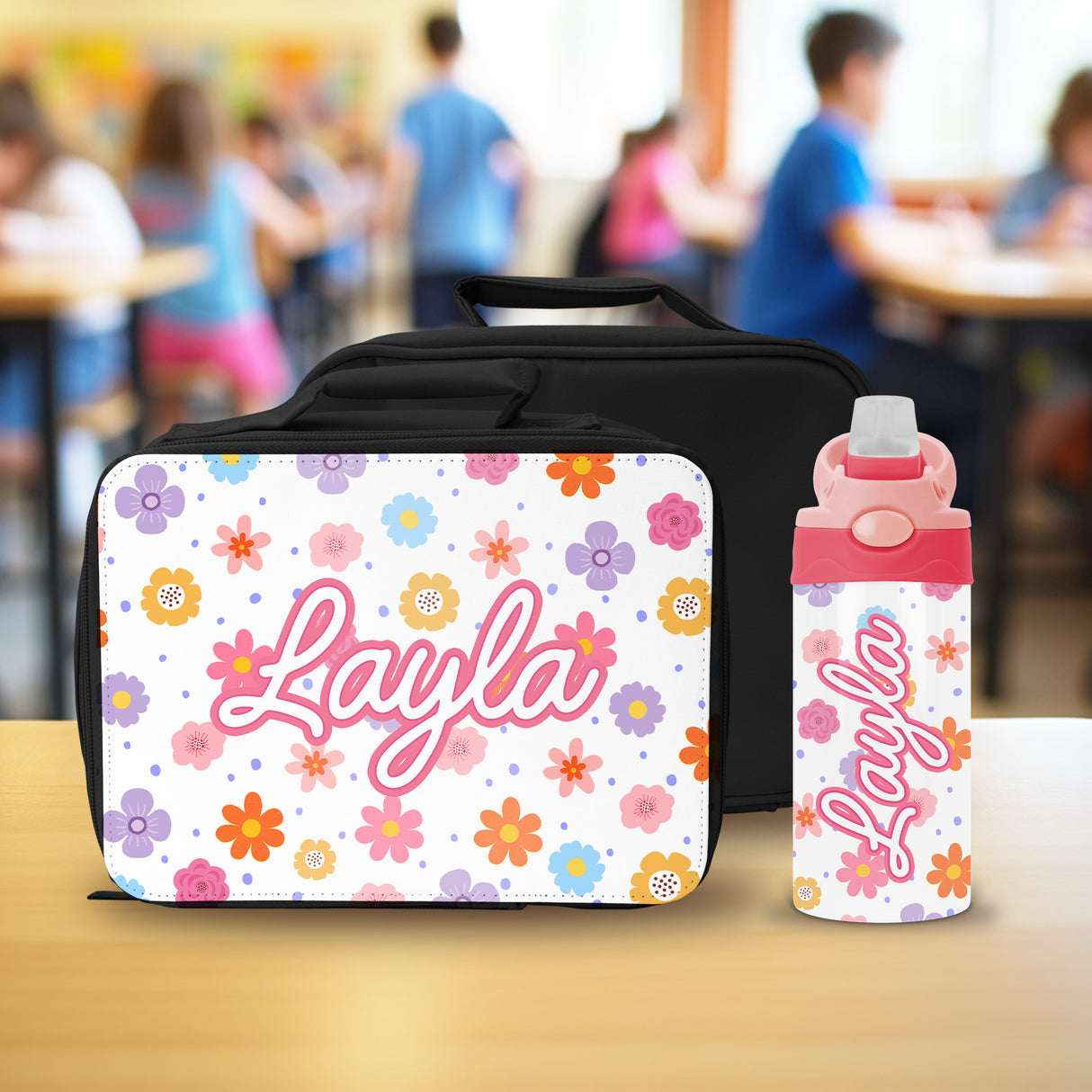 Custom lunch box with matching water bottle for girls school supplies with name and floral design.