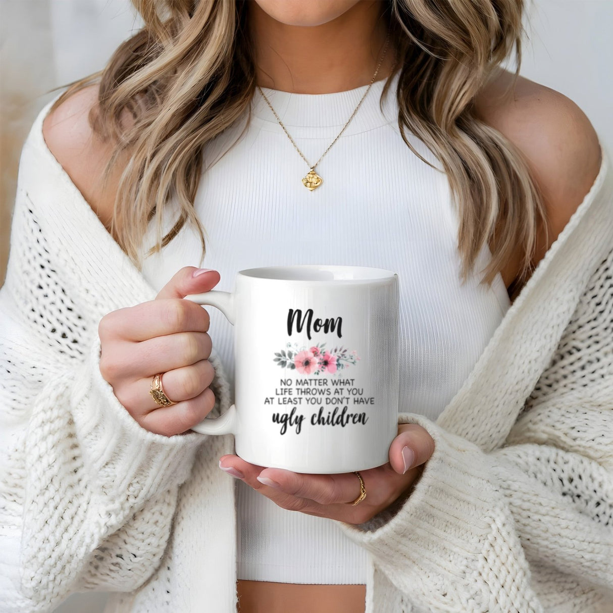 Woman holding funny coffee mug for mom with floral design and the quote. Mom holding a funny coffee mug.