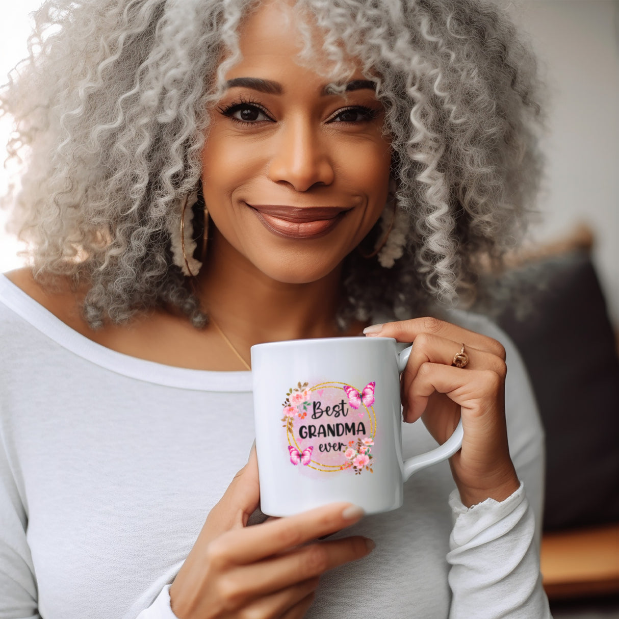 Grandma holding up adorable, best grandma ever mug for Mother's Day. Floral coffee mug for mom with personalized design, ideal gift for grandma, nana, or Mother’s Day gift.