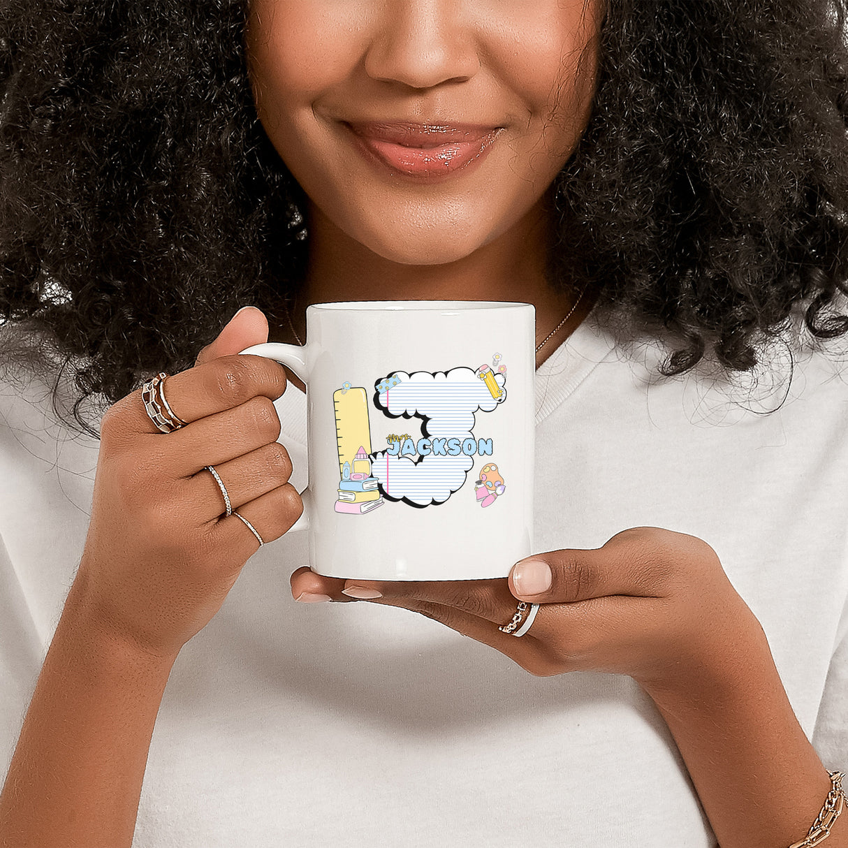 Woman holding personalized teacher mug with bubble letter, custom appreciation gift.