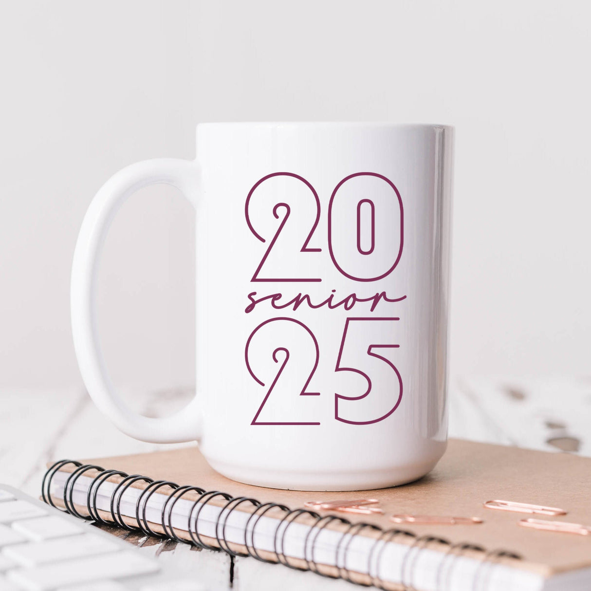 White ceramic mug for seniors, simple 2025 graduation gift for men or women. Minimalist grad mug for Class of 2025, unisex coffee cup design.