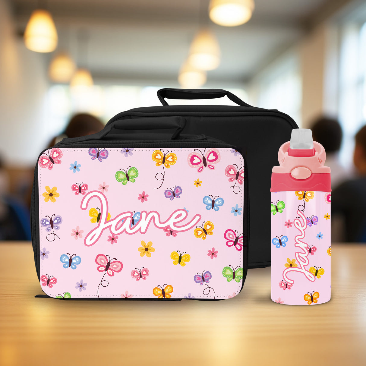 This personalized butterfly lunch set for girls includes a custom insulated lunch box and water bottle, perfect for school.