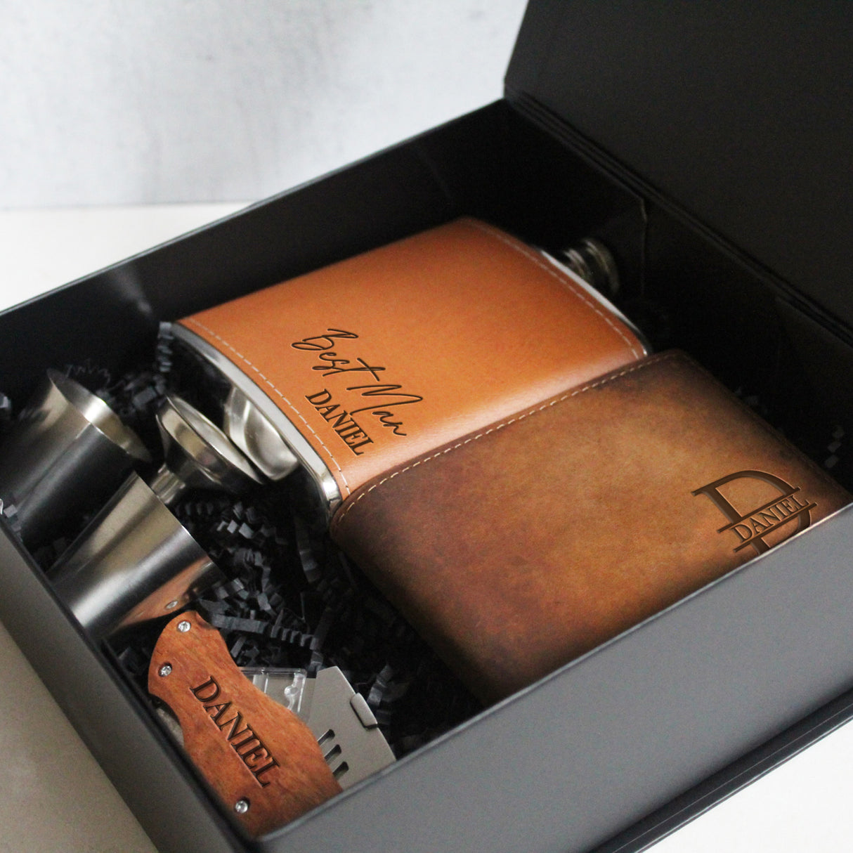 Stylish custom gift box for groomsmen proposals, including personalized items for bachelor party and wedding day.