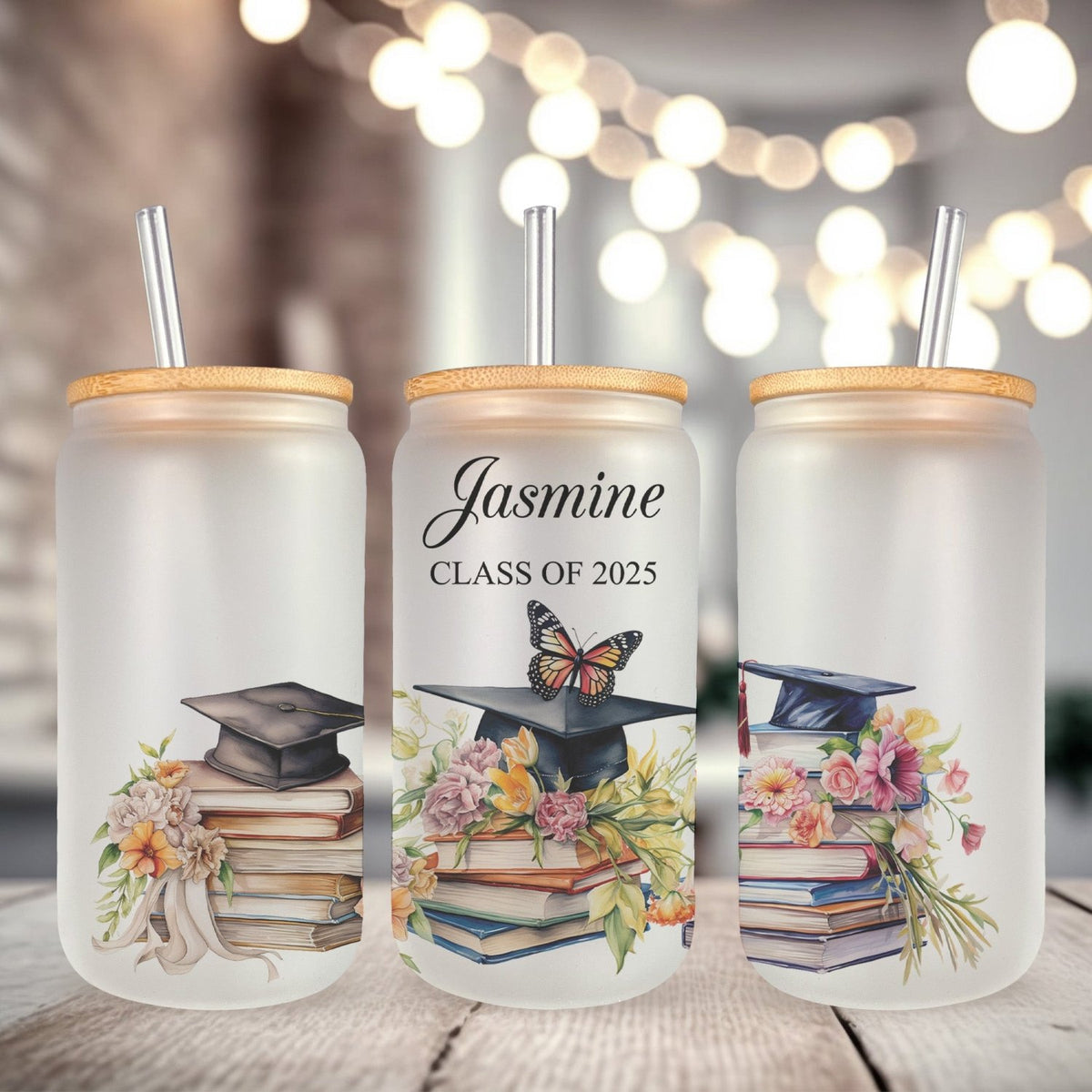 Trendy graduation glass cup with floral cap designed for Class of 2025 grads. Butterfly design on iced glass coffee cup for class of 2025 seniors.