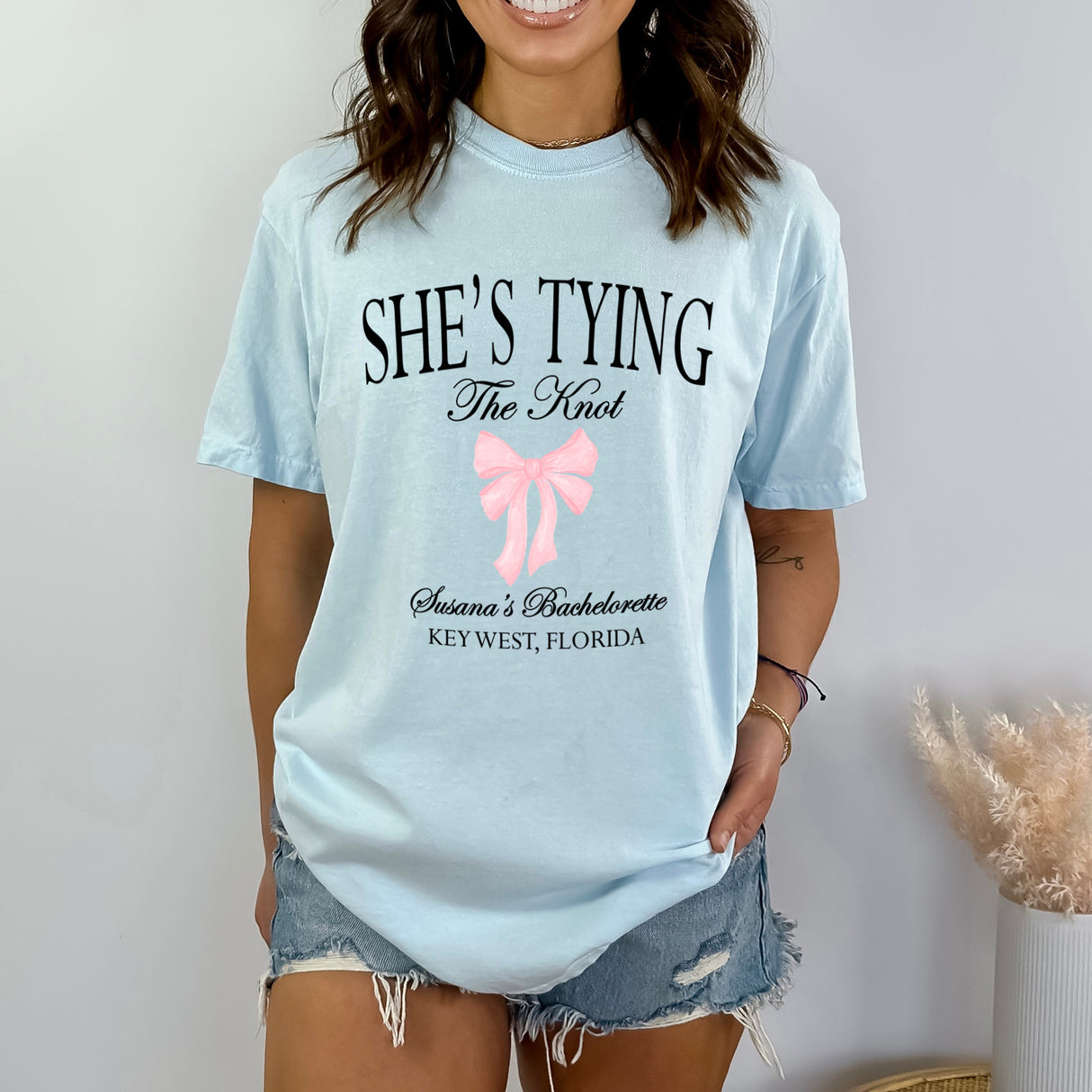 Gift for bridesmaid at a beach bachelorette or bridal shower, this matching Comfort Colors tee features custom names and a trendy bow design.