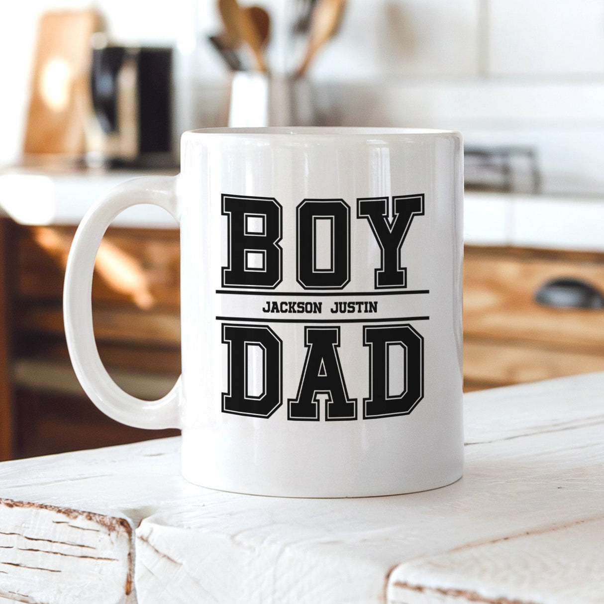 Personalized coffee mug for boy dad with kids names, custom Father’s Day gift, white ceramic mug displayed on kitchen counter.