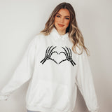 A cute Halloween Hoodie for women with a skeleton showing heart hands. all SKUs
