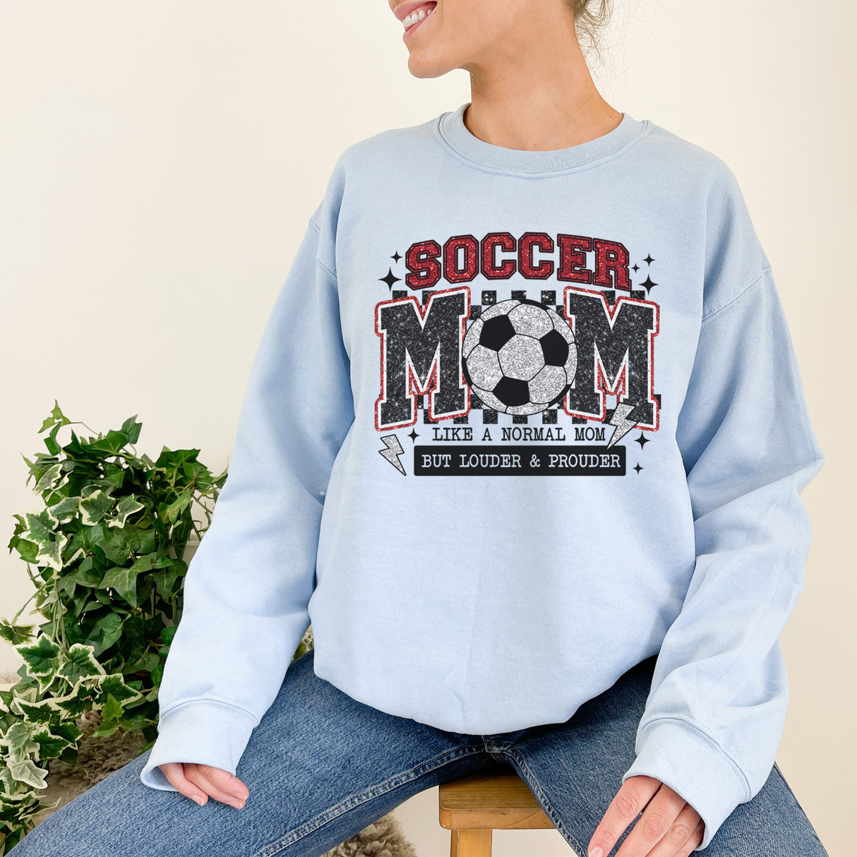 Trendy soccer mom wearing a sweatshirt in crewneck style, cozy and stylish for game day and everyday wear.