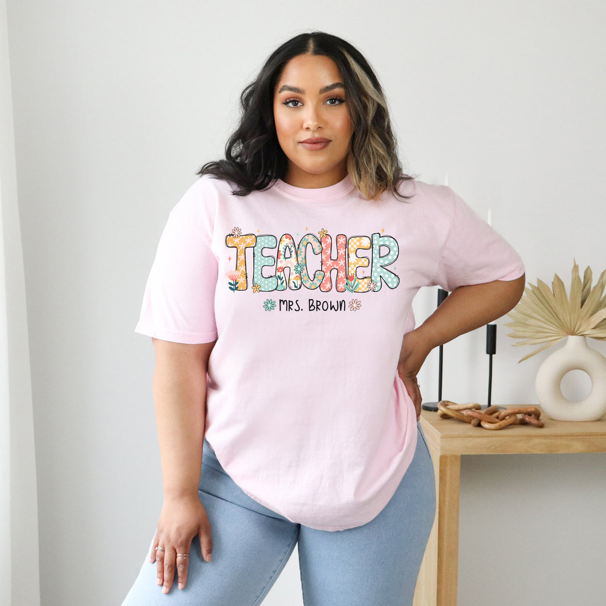 Female teacher wearing custom Comfort Colors shirt with personalized name, teacher appreciation gift crewneck.