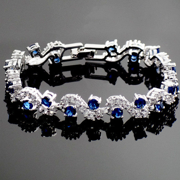 Stylish and hypoallergenic blue sapphire bracelet for women, showcasing sparkling Swarovski elements on a sleek link chain.