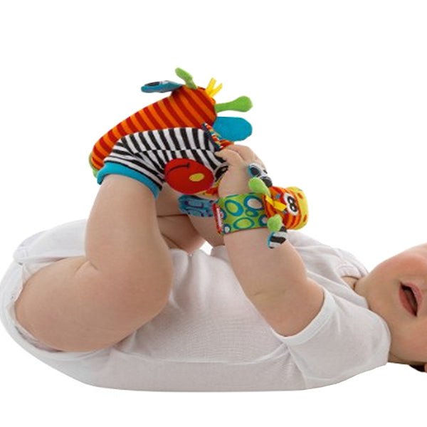 baby playing with hand foot finder rattles