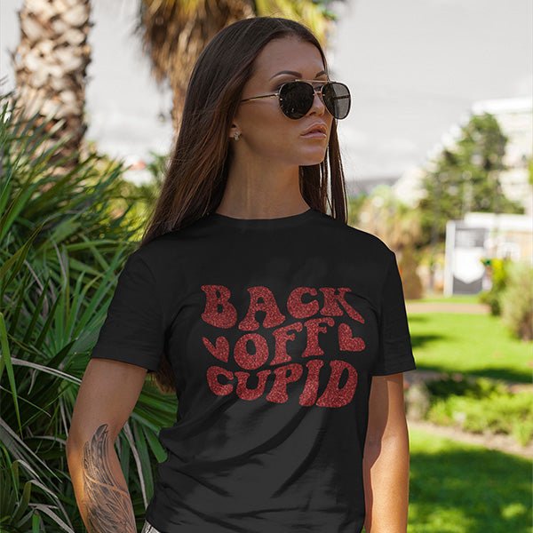 Anti valentine shirts with the phrase Back Off Cupid. Great for going to a Galentine party or wearing on Valentines Day. all SKUs