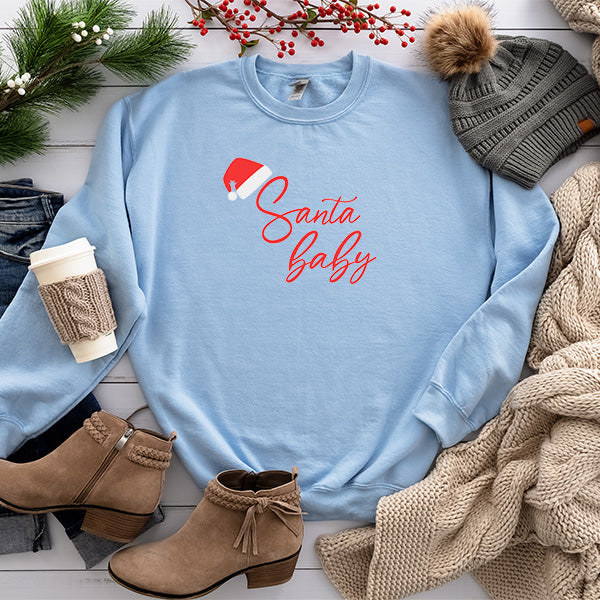Flat lay photo of light blue sweatshirt with Santa Baby design. Christmas sweatshirt for women in Small to 5XL sizes. all SKUs