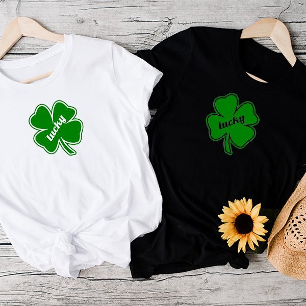 White and Black lucky shirts for St. Pattys Day Shirts. Features a Green Clover with the words Lucky in the middle. Get one for every member of the family or group.