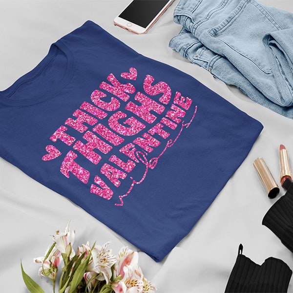 It's the perfect self love shirt with the text Thick Thighs Valentine Vibes. Choose from standard print or glitter print. While a variety of tshirts are available, you can also get these as a slouch tee, crop top, hoodie, tank top and more. all SKUs