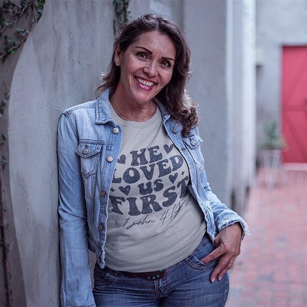 This shirt features the text He Loves Us First and the bible reference of 1 John 4-19. It's a great Christian shirt for youths, women and men. all SKUs