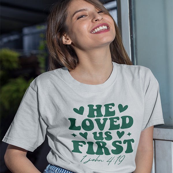 This shirt features the text He Loves Us First and the bible reference of 1 John 4-19. It's a great Christian shirt for youths, women and men. all SKUs
