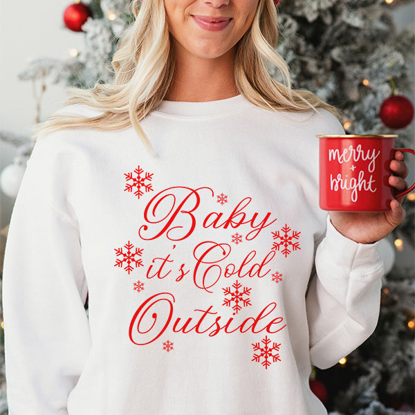 Baby It's Cold Outside White Christmas Sweatshirt with red print. Features stylish font with red snowflakes reflective of the holiday season. all SKUs