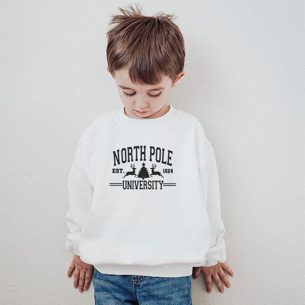 Little boy wearing our North Pole University sweatshirt. all SKUs