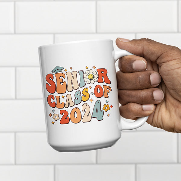 Man holding Senior class of 2024 coffee mug designed for this years 2024 graduate. All SKUs. 