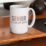 Senior class of 2024 coffee mug sitting on a wooden desk. All SKUs.