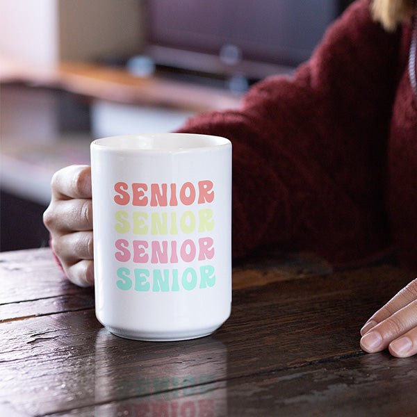 senior class 2024 coffee mug sitting on a wooden table. A graduation gift for her. All SKUs.