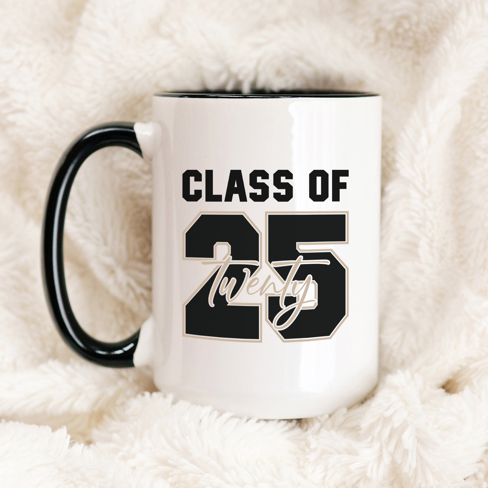 Graduation coffee mug featuring bold Class of 2025 lettering. Ceramic graduation mug with black handle and Class of 2025 print, perfect senior gift idea.