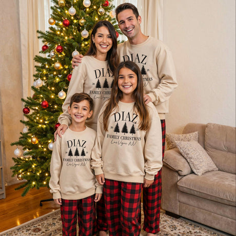 Custom family matching Christmas pajamas. Personalized Christmas sweatshirts with last name and location, paired with red and black plaid pajamas. Sizes available from newborn to 5XL. 