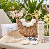 Bride gifts for bachelorette party with cute beach essentials like a personalized 40oz tumbler and personalized straw hat.