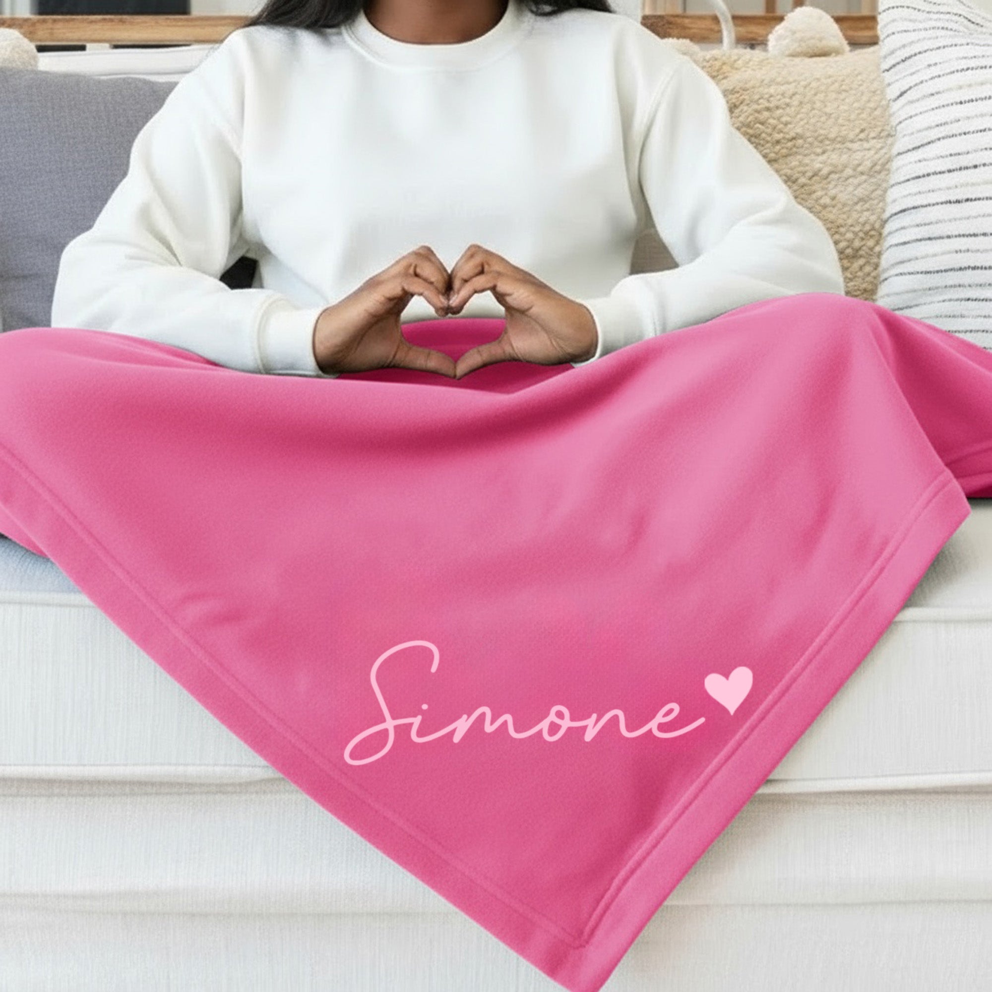 Pink fleece sweatshirt blanket personalized with name for bedroom, dorm room, game days, and gifts for teen girls.