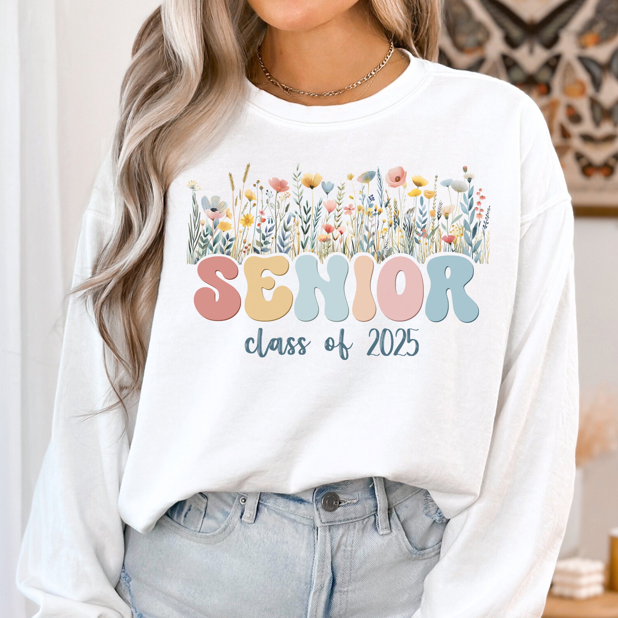 Girl wearing Floral 2025 Comfort Colors sweatshirt. Class of 2025 graduate in Floral Pastel Comfort Colors sweatshirt, perfect for graduation.