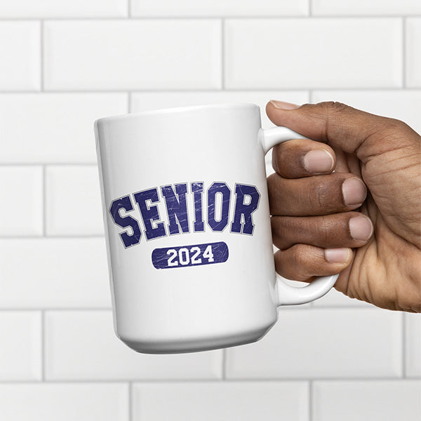 Man holding a Senior 2024 coffee mug designed to be a gift for 2024 senior graduates. All SKUs. 