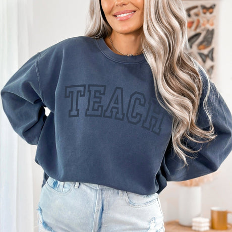 Comfort Colors crewneck sweatshirt with Teach varsity design in aesthetic tones. Good teacher gift ideas for this school year. 