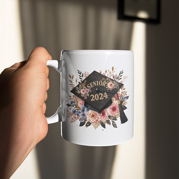 A Floral Senior 2024 design on a white 11oz coffee mug. The perfect graduation gift for her. All SKUs. 