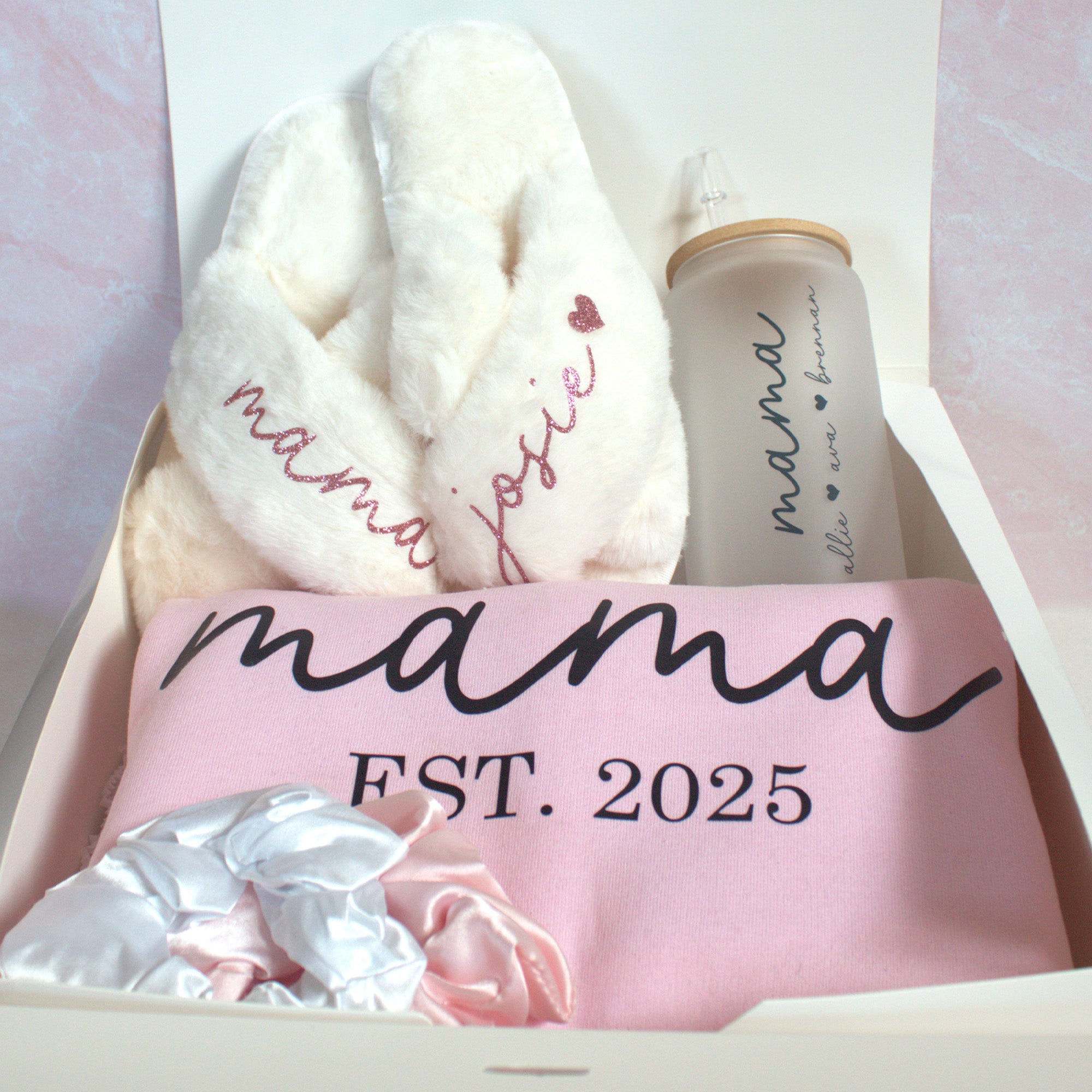 Cute Mother’s Day gift bundle with custom Mama sweatshirt, fluffy slippers, Libbey glass coffee can, and scrunchies. The best gift basket for mom. 